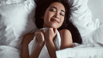 Portrait of a beautiful sensual asian woman under blunket