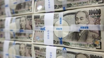 Japanese yen notes are piled up after counting at a bank during a photo opportunity in Seoul