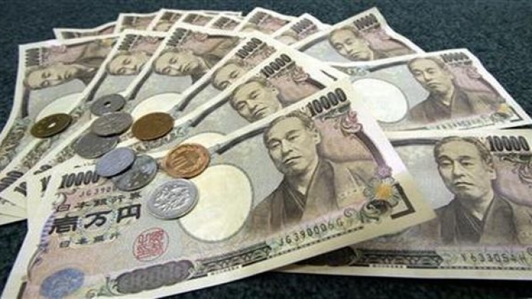 Japanese 10,000 yen bank notes and coins are displayed March 3, 2006. The yen fell on Friday after J..