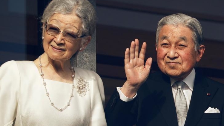 Empress Emerita Michiko and Emperor Emeritus Akihito wave to well-wishers during a public appearance for New Year celebrations at the Imperial Palace in Tokyo