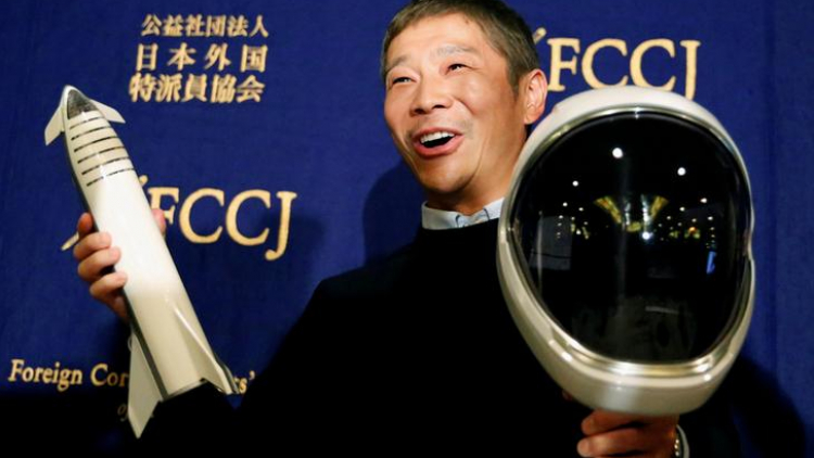 FILE PHOTO: Japanese billionaire Maezawa, founder and chief executive of online fashion retailer Zozo, who has been chosen as the first private passenger by SpaceX, poses for photos as he attends a news conference in Tokyo
