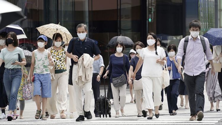 Orang-orang berjalan dengan masker untuk mencegah penyebaran virus corona covid-19 bekerja kembali japanesestation.com
