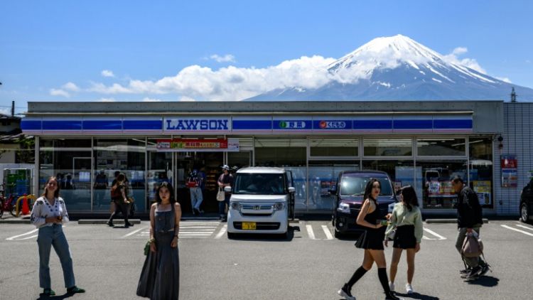 Turis asing berfoto di depan Lawson yang menampilkan pemandangan Gunung Fuji (AFP via Japan Today). Turis asing berfoto di depan Lawson yang menampilkan pemandangan Gunung Fuji (AFP via Japan Today).
